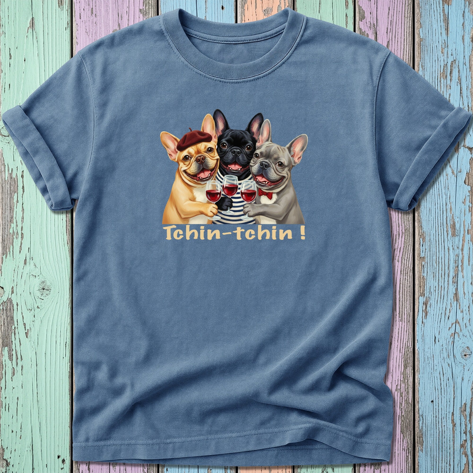 Three French Bulldogs wearing berets toast with wine glasses.