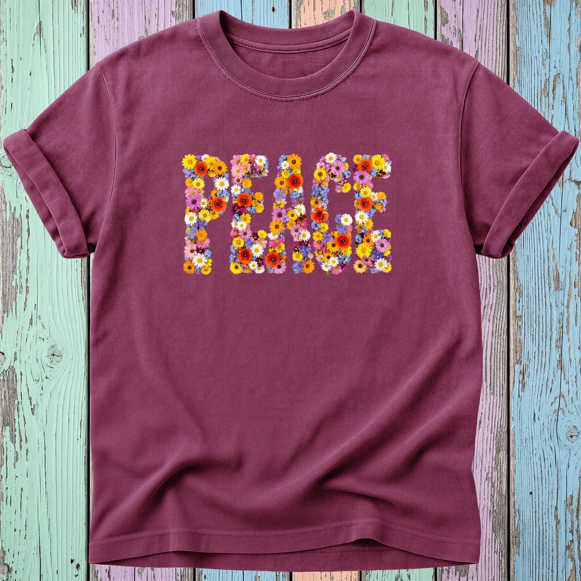 Maroon t-shirt with the word PEACE spelled out in colorful flowers.