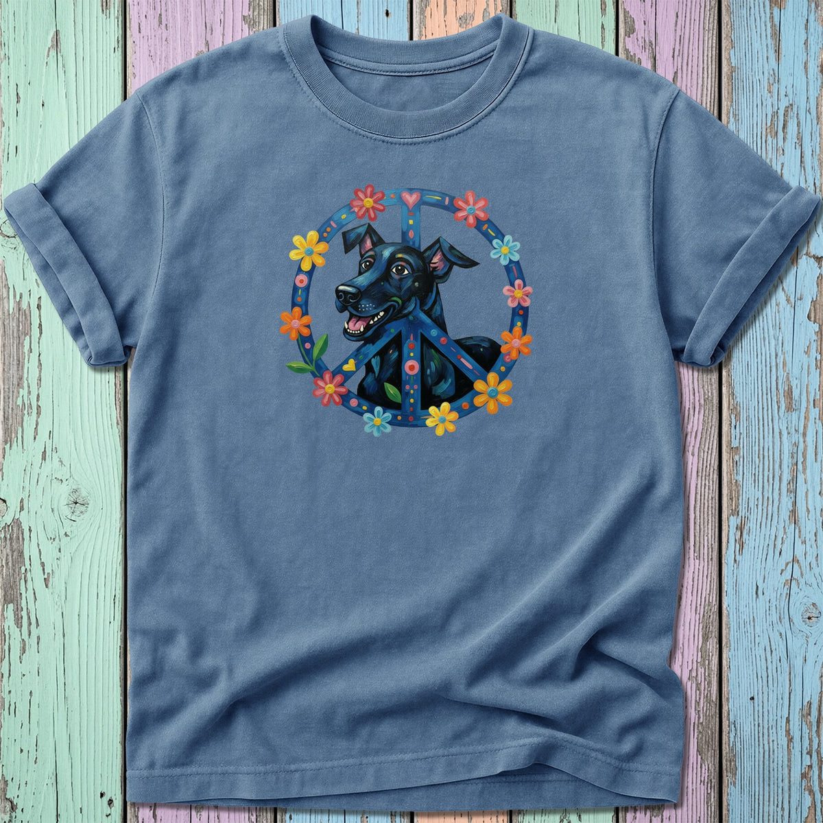 Black dog inside a colorful peace sign with flowers on a blue t-shirt.