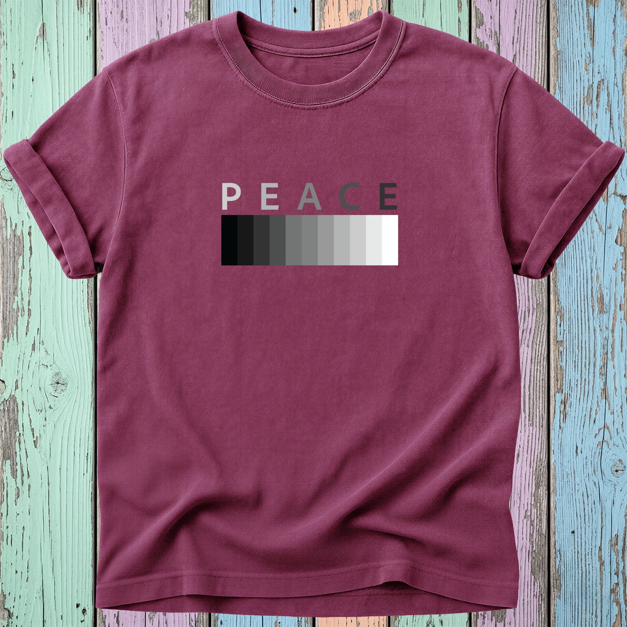 Maroon t-shirt with "PEACE" in varying shades of gray against a white gradient.