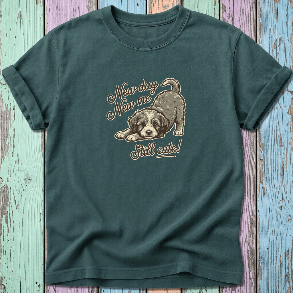 Dark teal t-shirt with a drawing of a puppy and text "New day New me Still cute!"