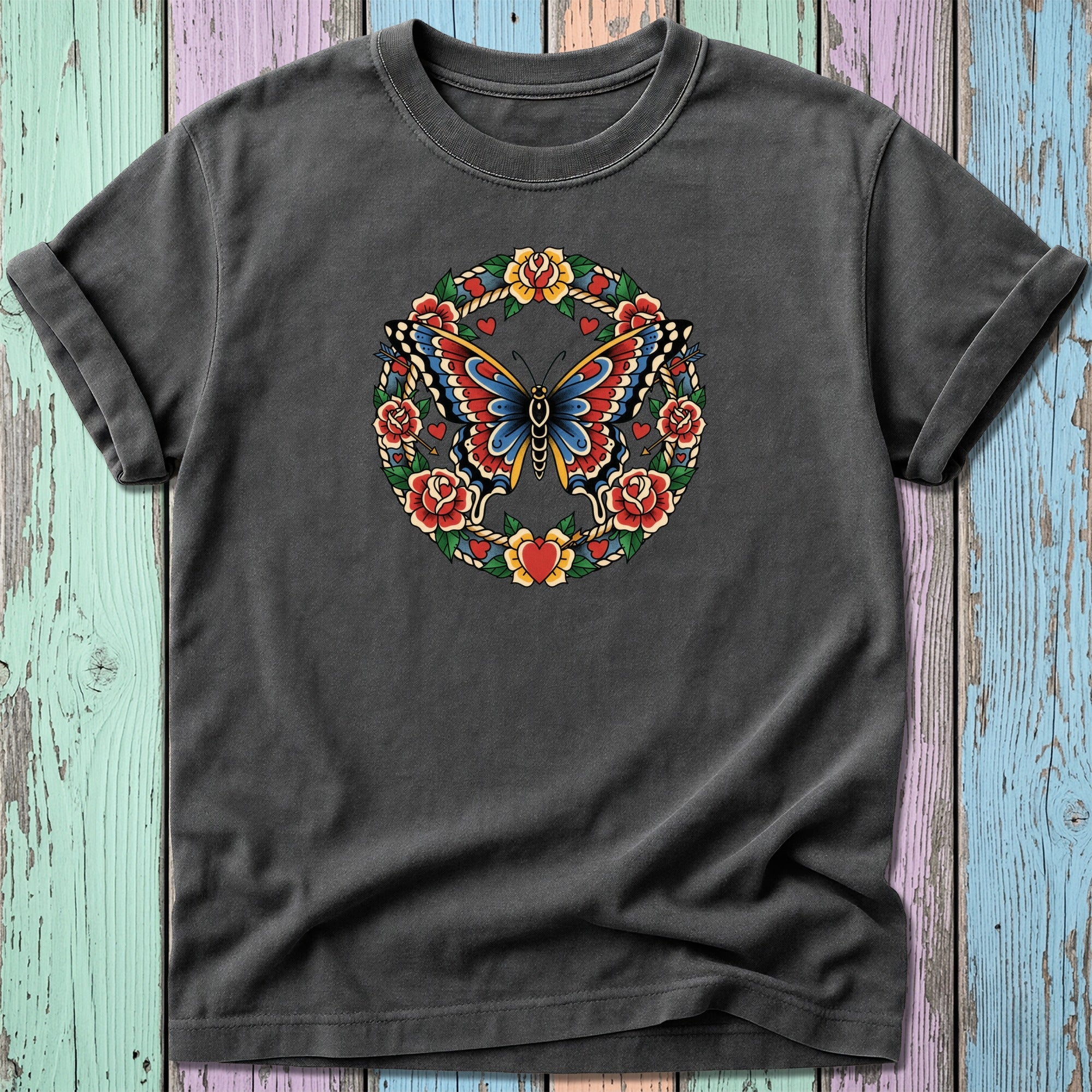 Dark t-shirt with a colorful butterfly and floral wreath design.