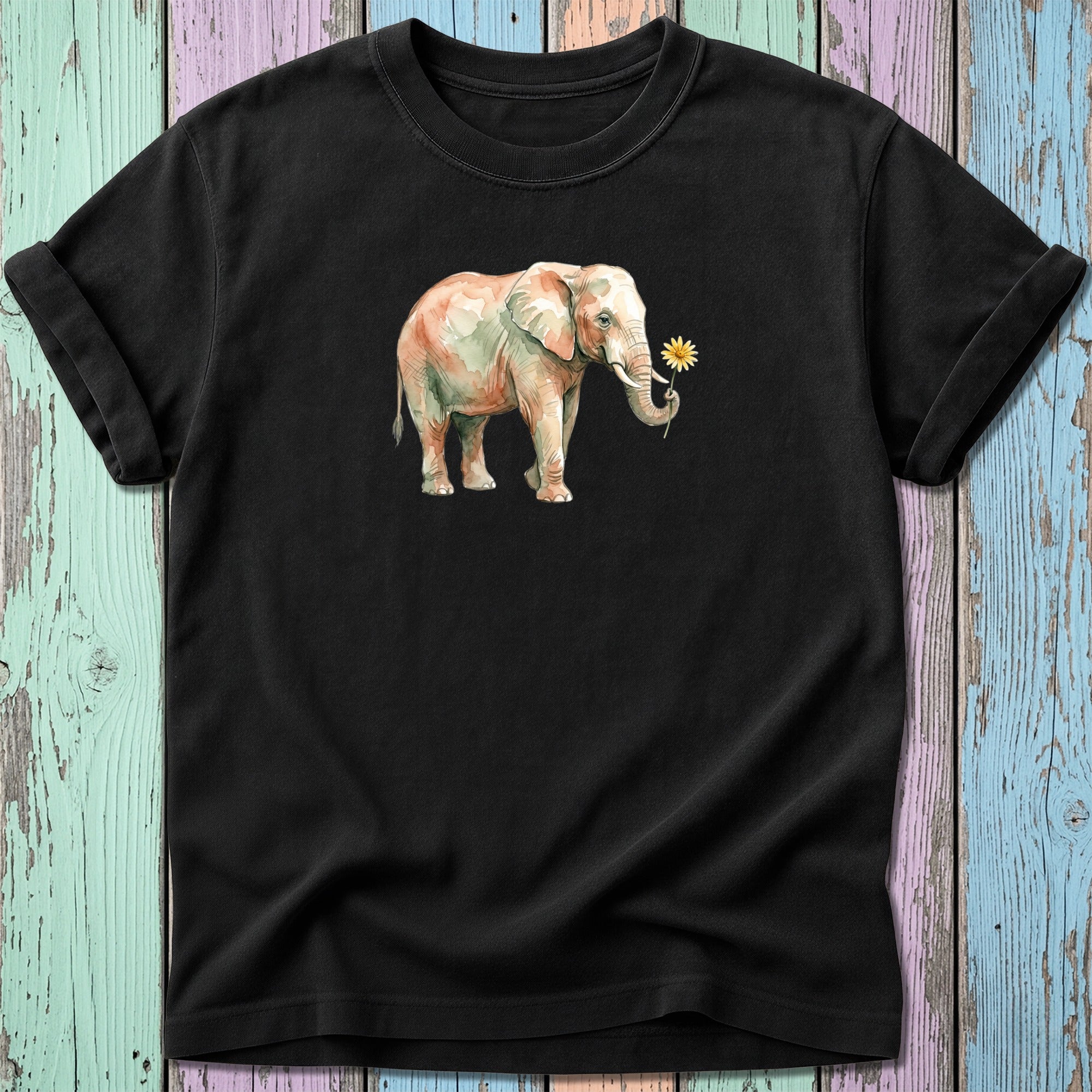 Black t-shirt with watercolor painting of an elephant holding a yellow flower.