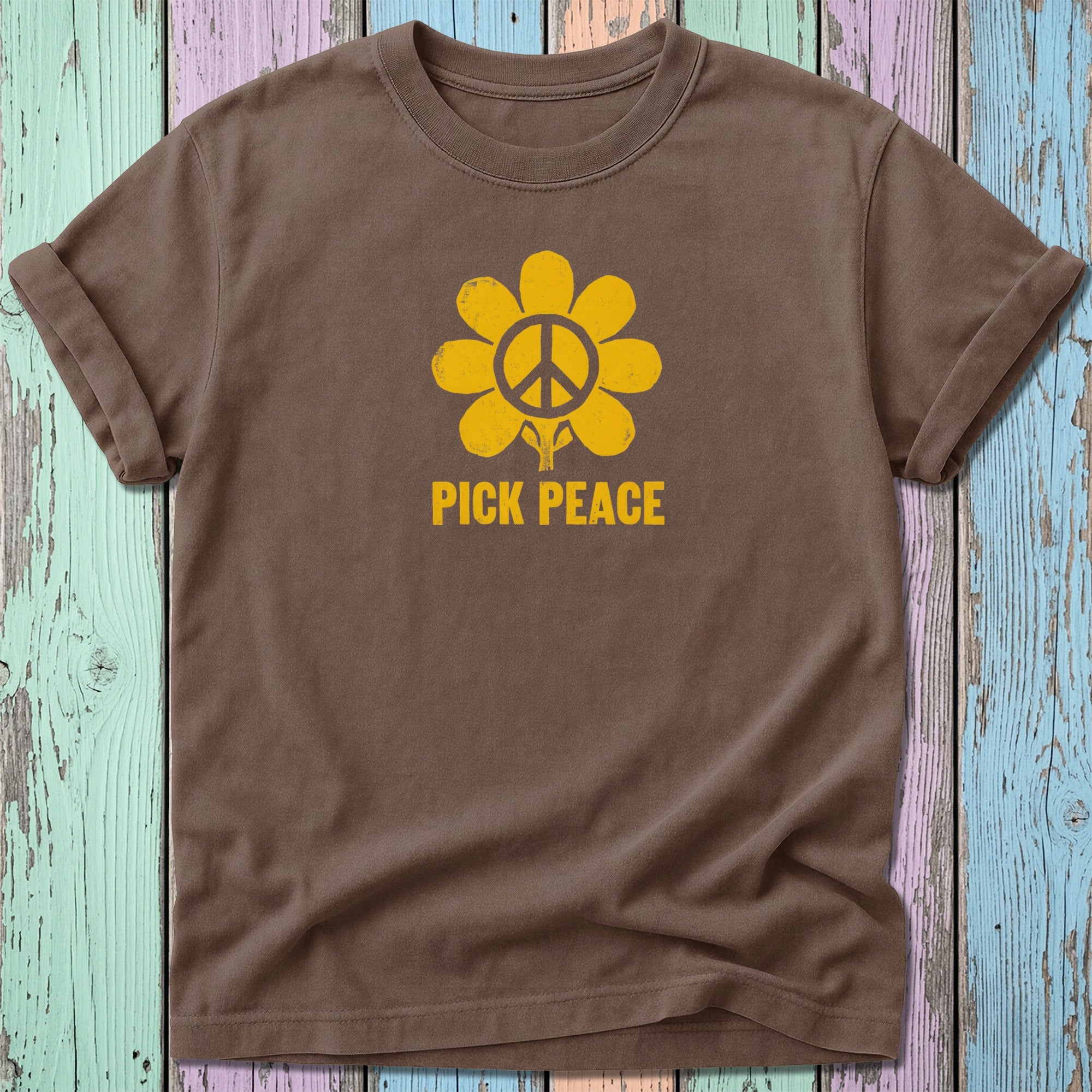Brown t-shirt with yellow peace sign flower graphic and "PICK PEACE" text.