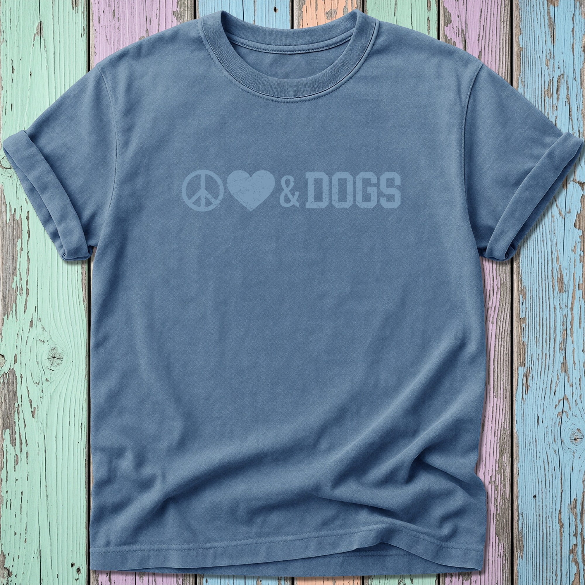 Blue t-shirt with peace, heart, and dogs graphic design.
