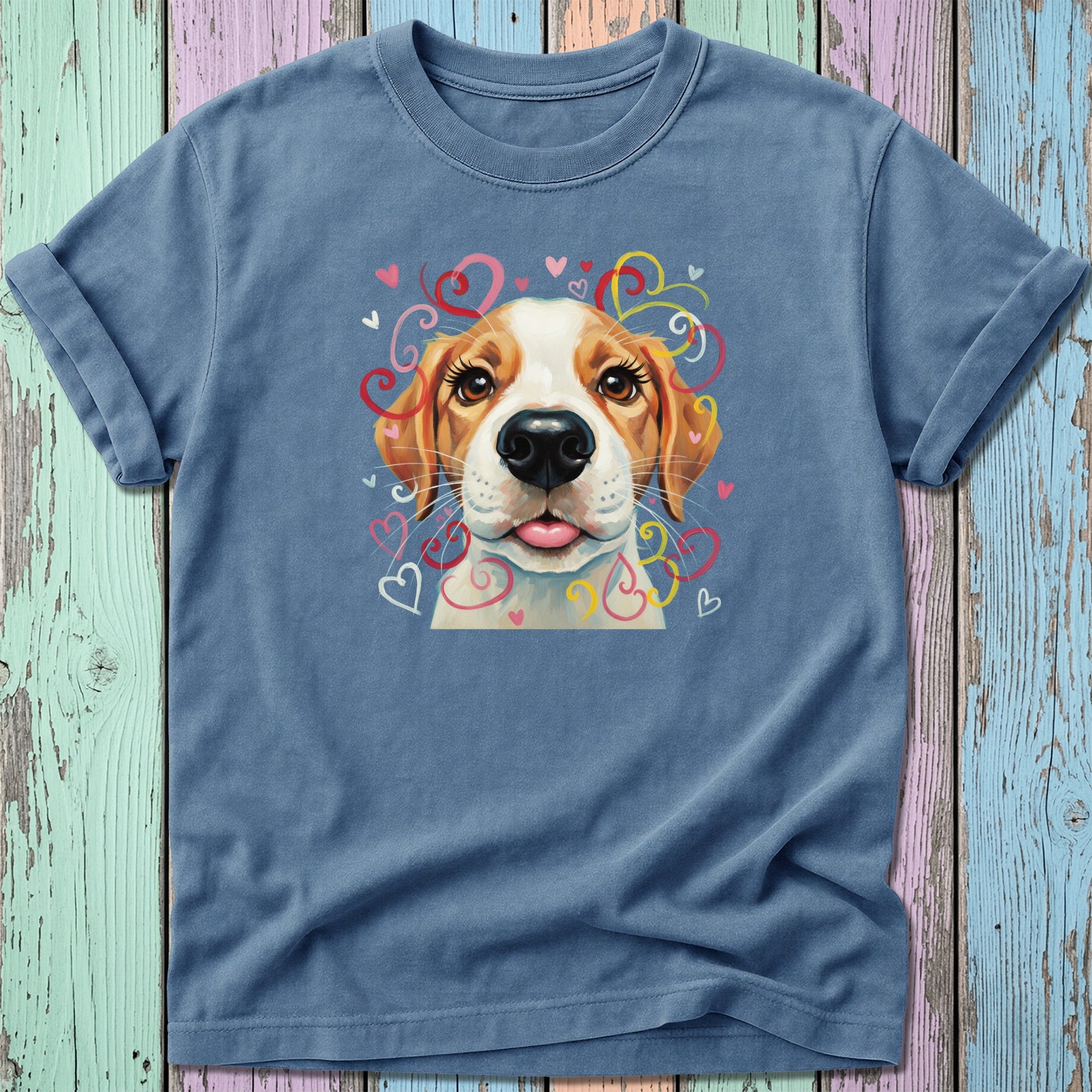 Blue t-shirt with a puppy's face surrounded by colorful hearts and swirls.