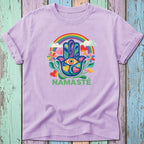Lavender t-shirt with rainbow Hamsa hand, eye, flowers, and "NAMASTÉ" text.
