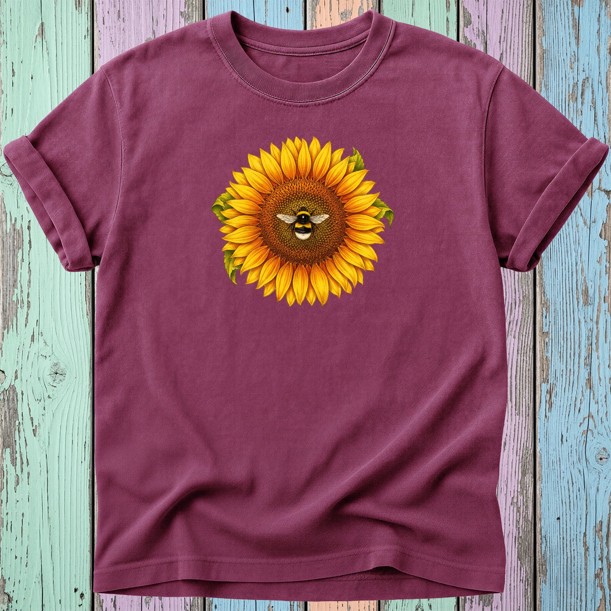 Burgundy t-shirt with a sunflower and bee graphic.