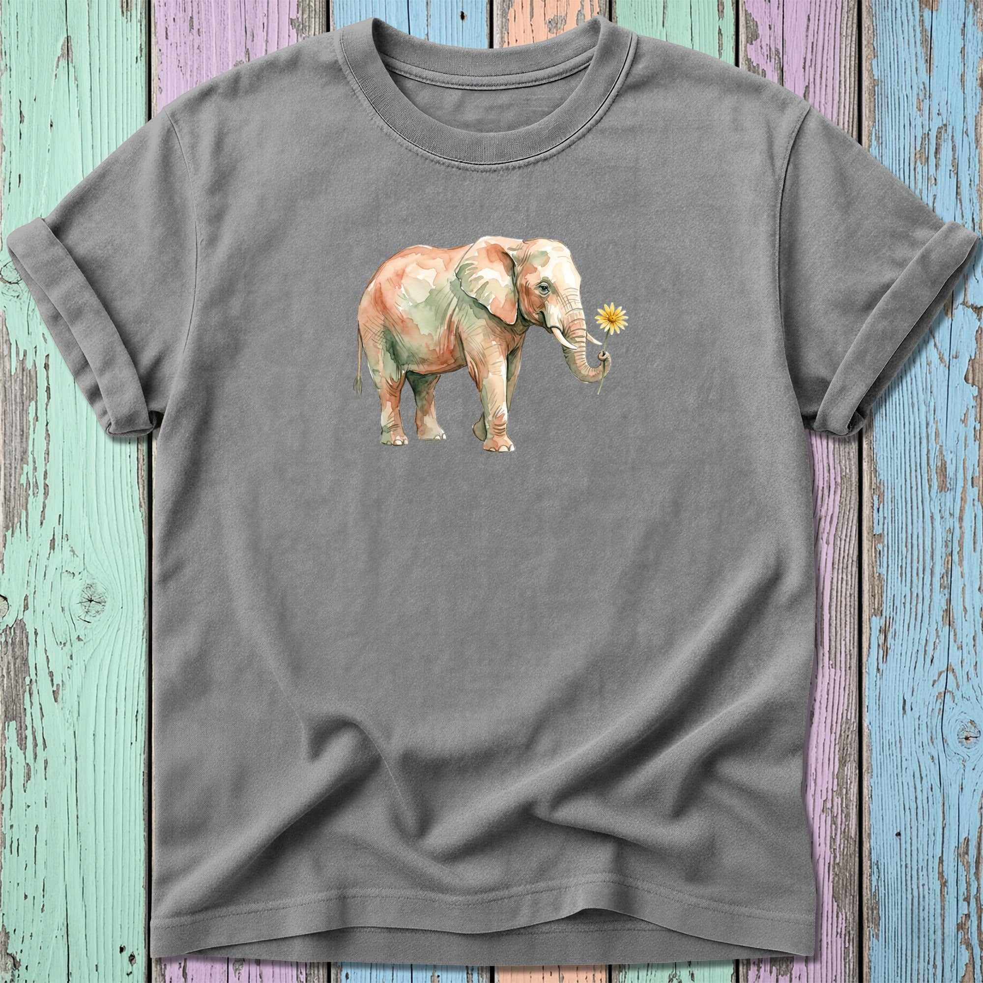 Watercolor elephant holding a daisy, on a grey t-shirt.