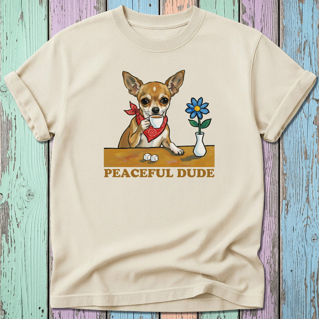 Chihuahua wearing bandana drinks coffee next to a flower.