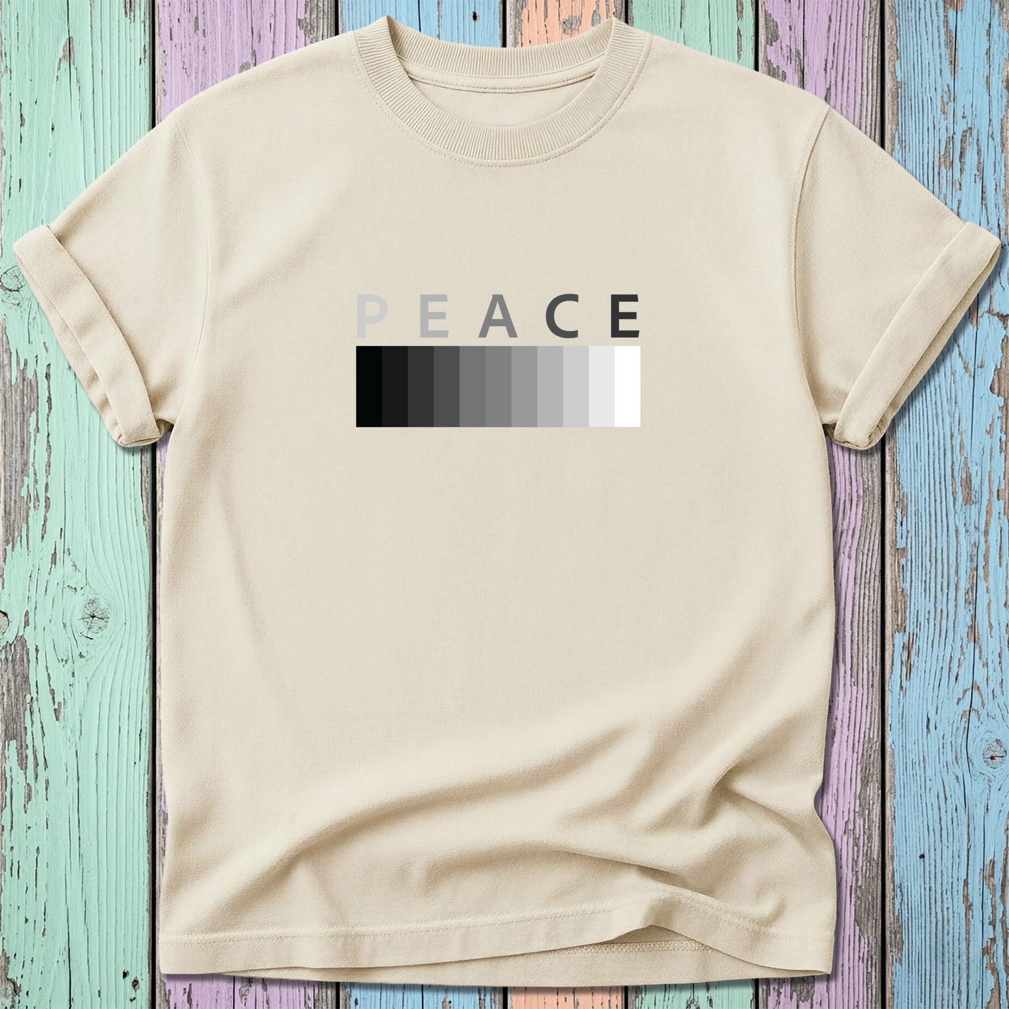 Cream t-shirt with "PEACE" in a grayscale gradient box.