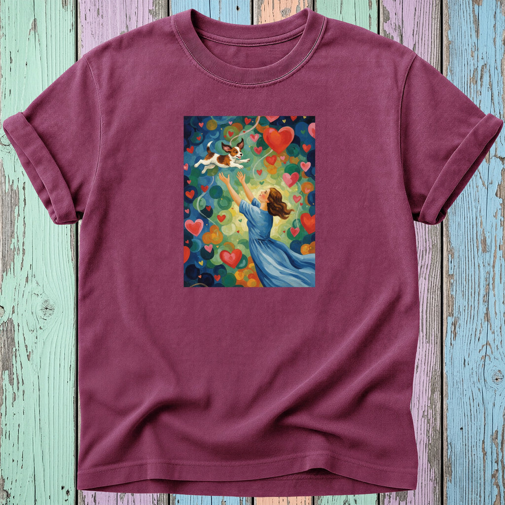 Woman in blue dress reaching for dog amidst colorful hearts.