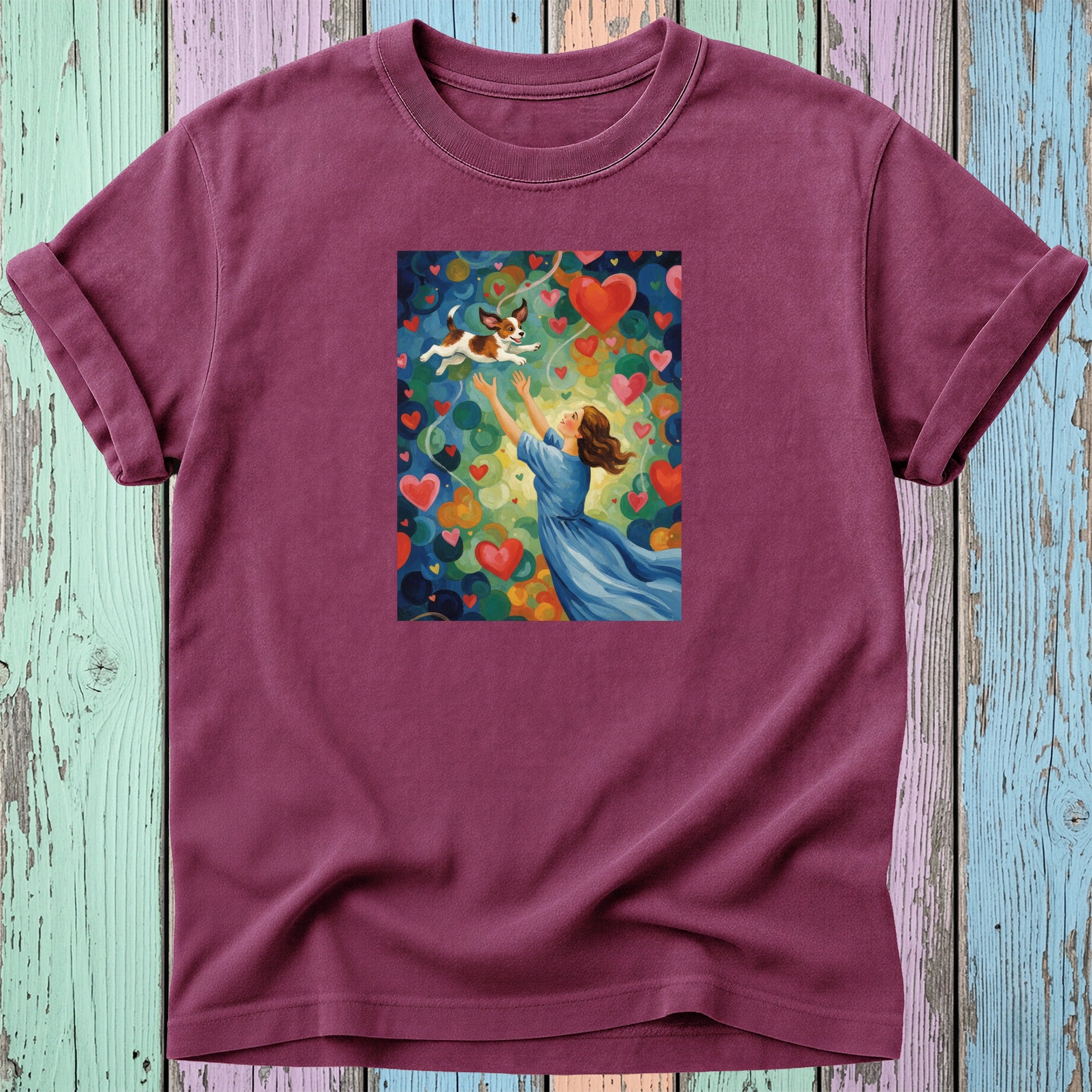 Woman in blue dress reaching for dog amidst colorful hearts.