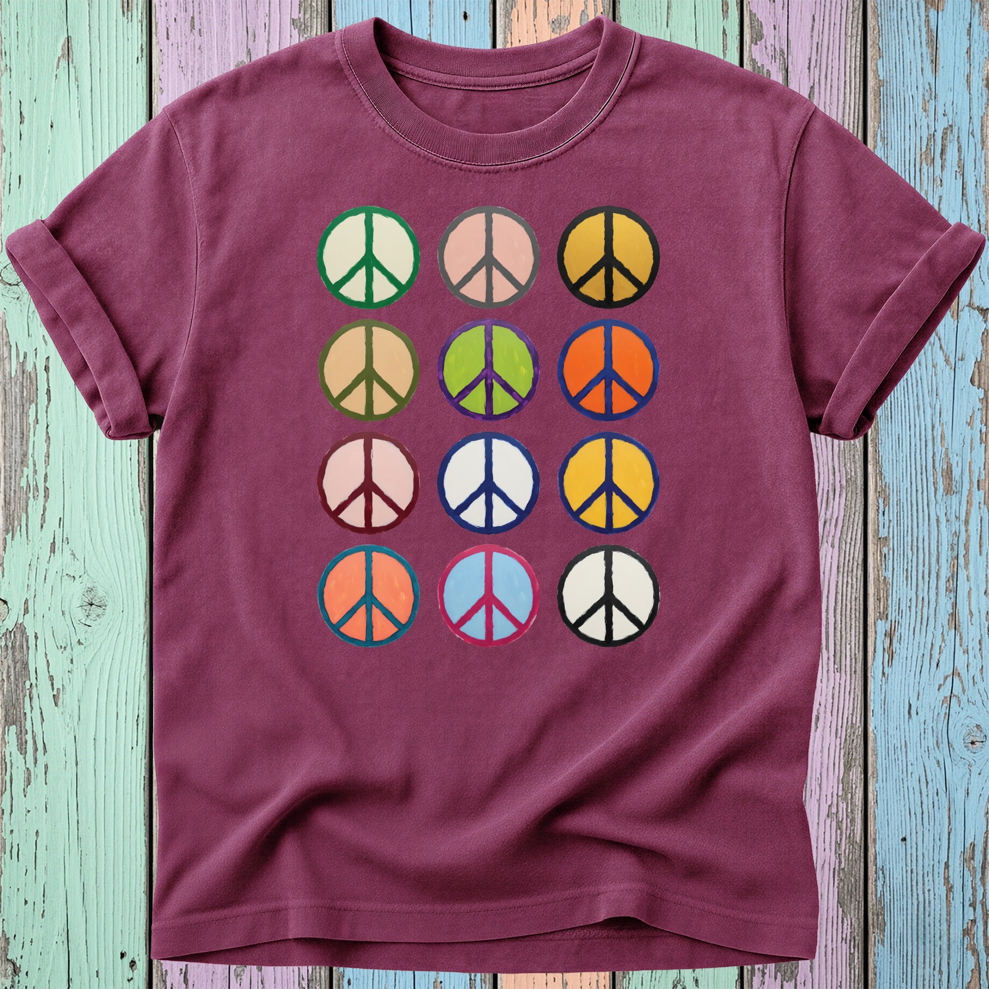 Maroon t-shirt with a grid of colorful peace sign graphics.
